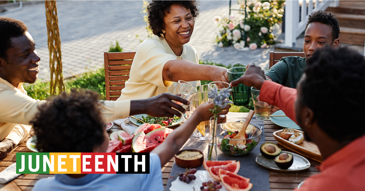 Black Americans celebrating Juneteenth with food and laughter.